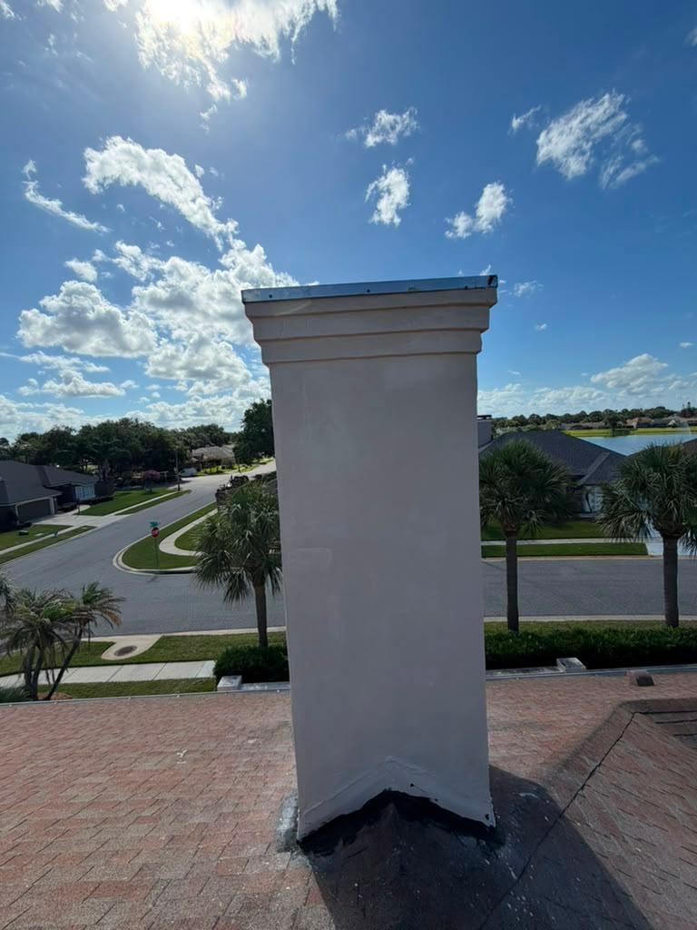 Freshly restored white chimney against a blue sky