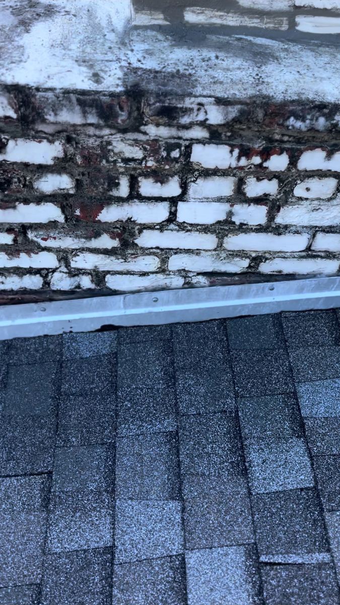 Weathered brick chimney before restoration