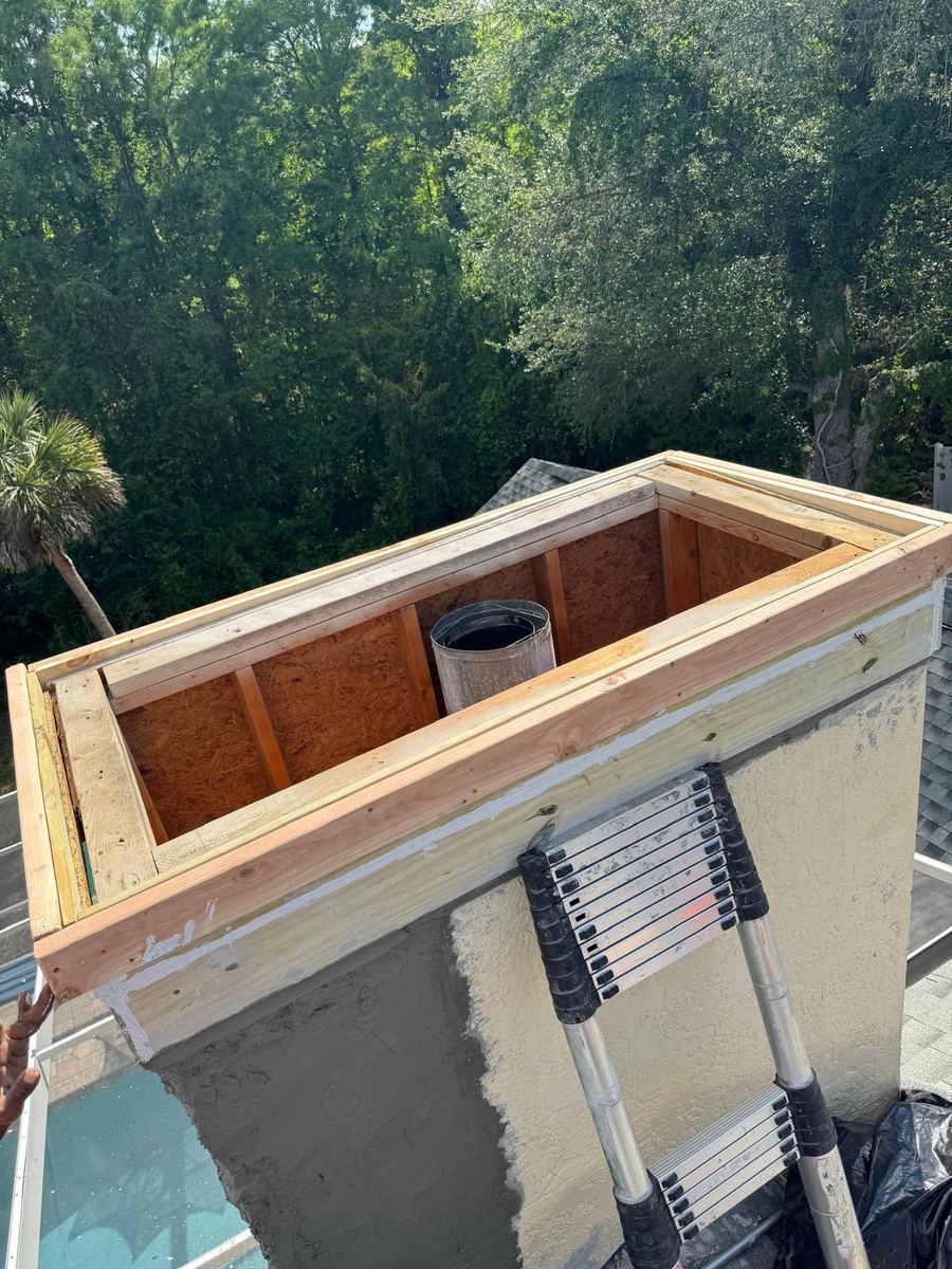 Top-down view of rebuilt chimney framing